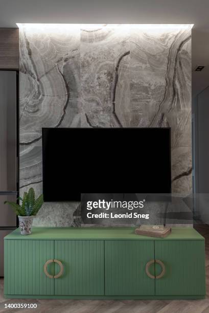 living room interior with tv on stone-faced wall and low console - bureau design stock pictures, royalty-free photos & images