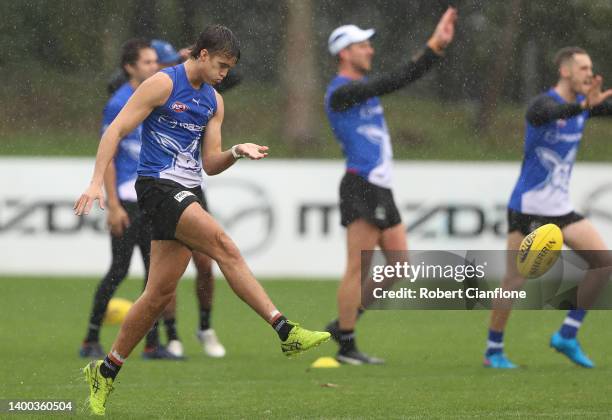 Flynn Perez of the Kangaroos kicks the ball during a North Melbourne Kangaroos Training Session AFL training session at Arden Street Ground on June...