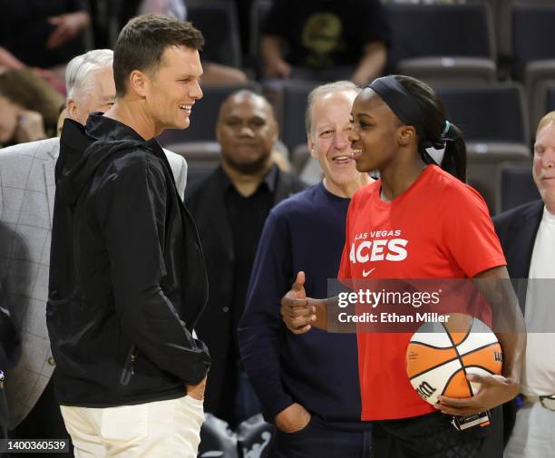 Tampa Bay Buccaneers quarterback Tom Brady talks with Jackie Young of the Las Vegas Aces during halftime of the Aces' game against the Connecticut...