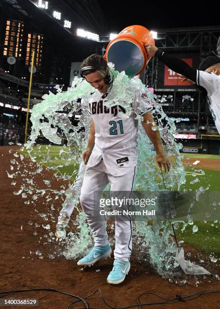 Cooper Hummel of the Arizona Diamondbacks is doused with ice water after hitting an RBI double in the 10th inning to beat the Atlanta Braves 8-7 at...