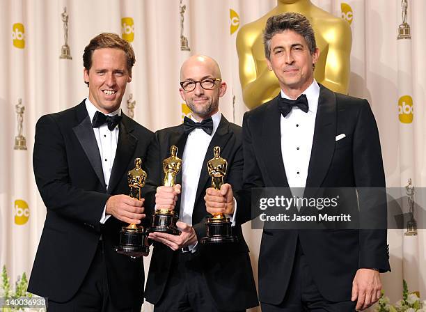 Screenwriters Nat Faxon, Jim Nash and Alexander Payne, winners of the Best Adapted Screenplay Award for 'The Descendants,' pose in the press room at...