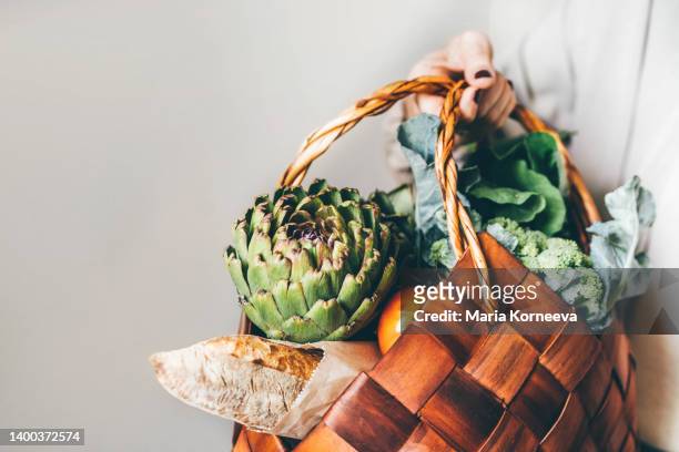 wicker basket with various organic vegetables from market at woman hand. - hands full stock pictures, royalty-free photos & images