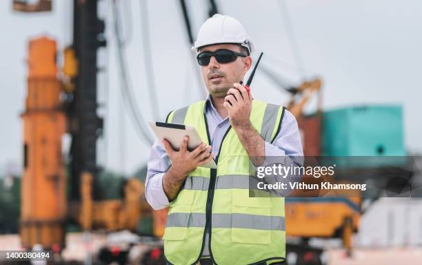 civil engineers control and inspection whit pile installation machine. - engineering earth stock pictures, royalty-free photos & images