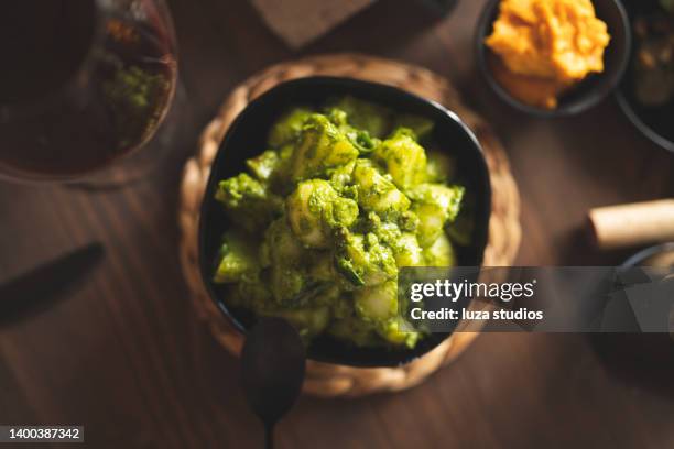 dinner with green pesto potato salad - potato salad stock pictures, royalty-free photos & images