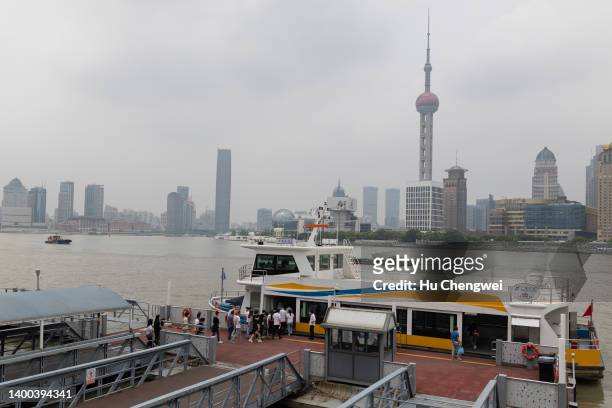 People take the ferry over the Huangpu river to the Bund on June 01, 2022 in Shanghai, China. The city of Shanghai, the country's economic centre and...