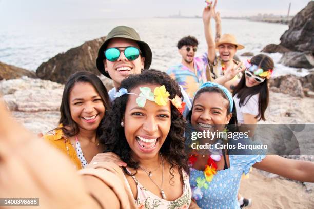 happy selfie of colleagues having fun at a beach party. - spring break stock pictures, royalty-free photos & images