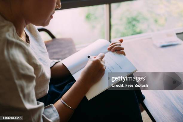 anonymous woman writing diary - schrijven stockfoto's en -beelden