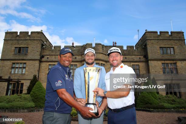 Michael Campbell of New Zealand, Peter Uihlein of The United States and Graeme McDowell of Northern Ireland pose for a photograph with the trophy...