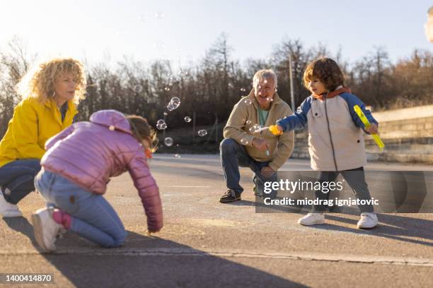 caucasian family playing together - family chalk drawing stock pictures, royalty-free photos & images