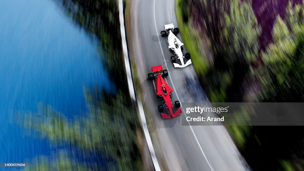 Red race car leading on a race track