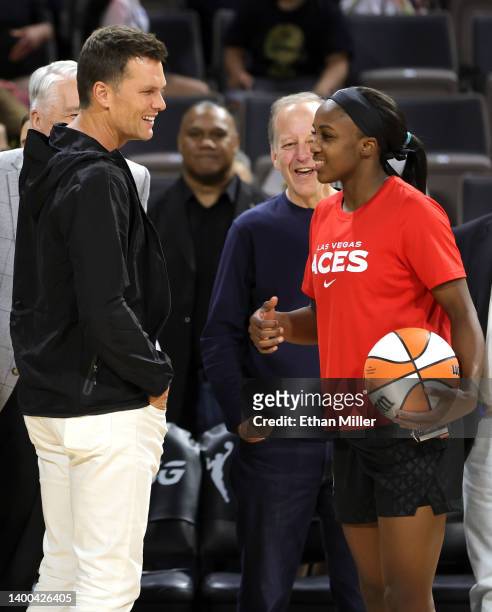 Tampa Bay Buccaneers quarterback Tom Brady talks with Jackie Young of the Las Vegas Aces during halftime of the Aces' game against the Connecticut...
