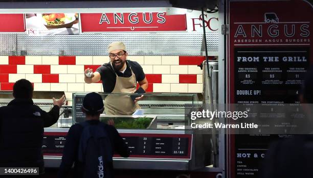 Burger van chef hands the match ball back to fans after it landed inside his mobile vending unit after being hit for a six during the Vitality T20...