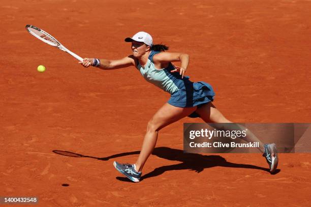 Iga Swiatek of Poland stretches to play a forehand against Jessica Pegula of The United States during the Women's Singles Quarter Final match on Day...