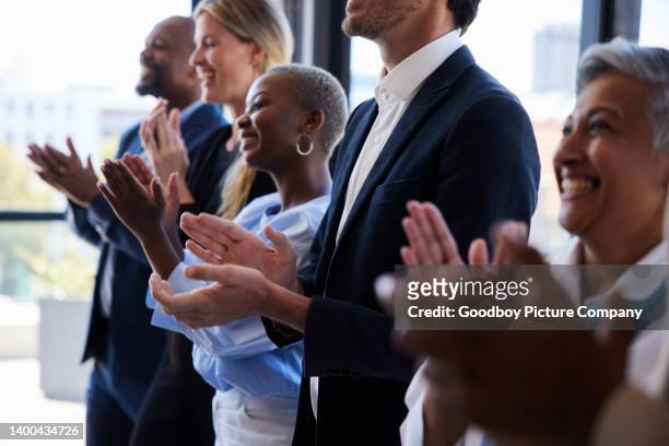 diverse businesspeople smiling and clapping after a presentation in a boardroom - awards ceremony stock pictures, royalty-free photos & images