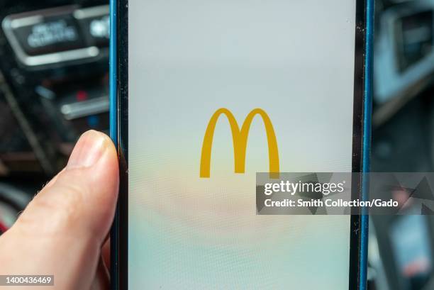 Person's hand holding an iPhone displaying the McDonald's app, Lafayette, California, May 2, 2022.