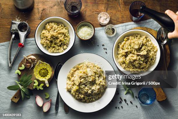 classic italian risotto with mushrooms on a wooden table - eating pesto stock pictures, royalty-free photos & images