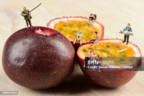 close-up of fruits on table with miniature people figurines - figurine bildbanksfoton och bilder