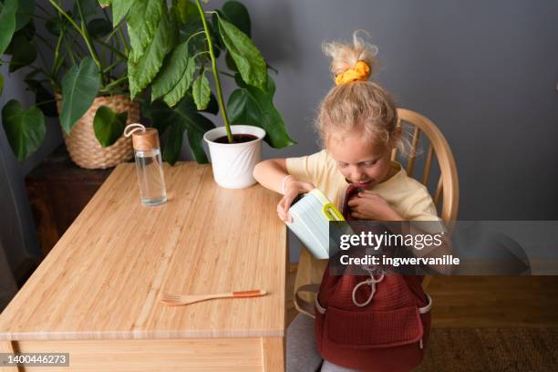 toddler girl packing lunch box in backpack - austria food stock pictures, royalty-free photos & images