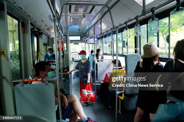 Passengers wearing face masks ride a bus on June 1, 2022 in Shanghai, China. Shanghai gradually restored production and daily life starting on...