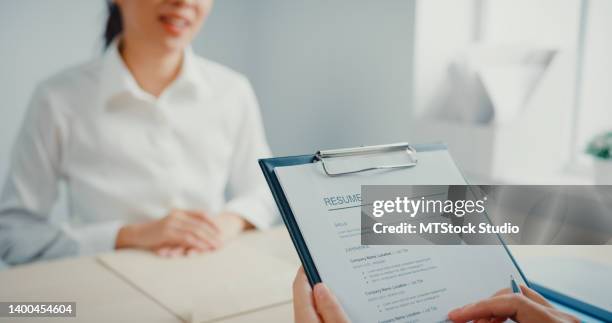 close up of asian businesswoman interviewing for a job while discussing the resume at office. - cv bildbanksfoton och bilder