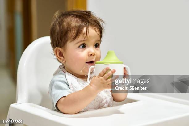 cute baby girl drinking milk - baby cup fotografías e imágenes de stock