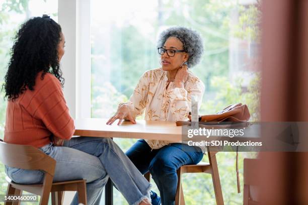 mother and daughter meet for lunch - 20s talking serious stock pictures, royalty-free photos & images