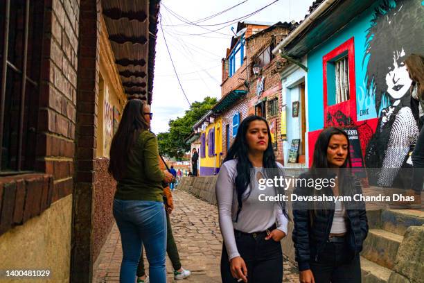 bogota, colombia - local colombians on the calle del embudo, in the historic la candelaria district of the andes capital city in south america. - plaza del chorro de quevedo stock pictures, royalty-free photos & images