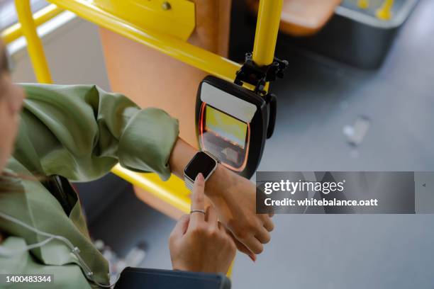 paying tram fare with smartwatch - smartwatch pay stock pictures, royalty-free photos & images