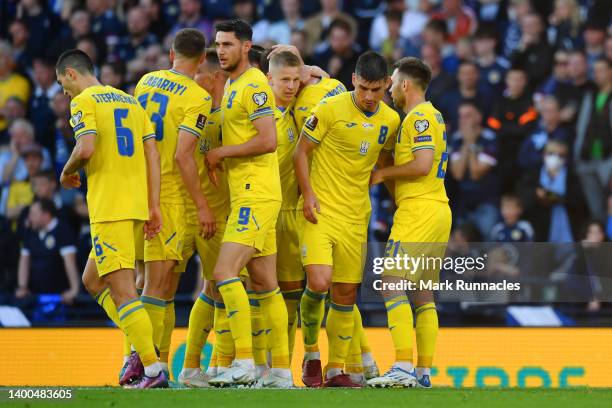 Andriy Yarmolenko of Ukraine celebrates with teammates after scoring their team's first goal during the FIFA World Cup Qualifier match between...