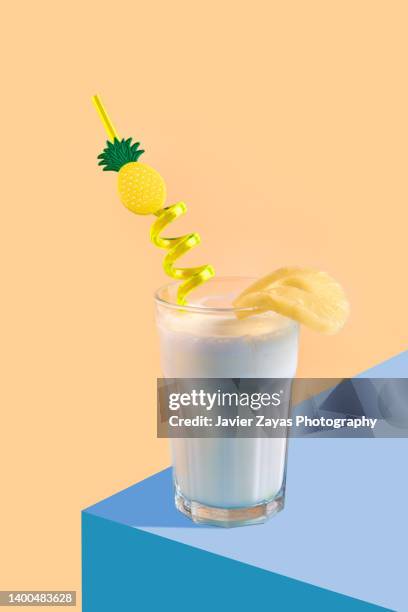 pina colada (pineapple smoothie) on yellow background - pina colada stock pictures, royalty-free photos & images