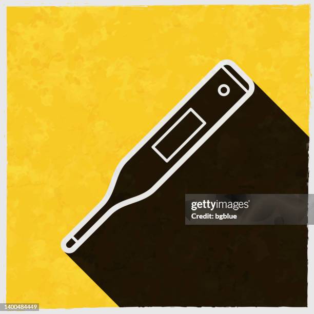 medical thermometer. icon with long shadow on textured yellow background - digital thermometer stock illustrations