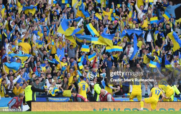 Roman Yaremchuk of Ukraine celebrates with teammates and fans after scoring their team's second goal during the FIFA World Cup Qualifier match...