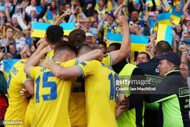 Roman Yaremchuk of Ukraine celebrates with teammates after scoring their team's second goal during the FIFA World Cup Qualifier match between...