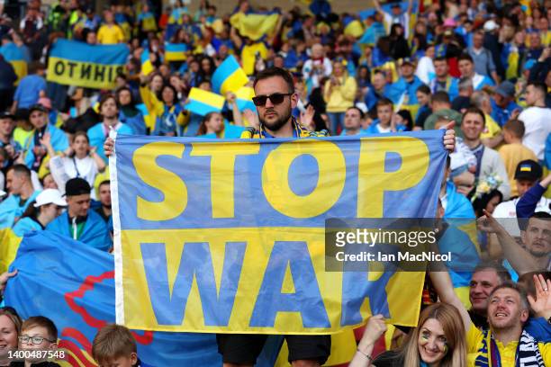 Ukraine fan holds a flag with a 'STOP WAR' message during the FIFA World Cup Qualifier match between Scotland and Ukraine at Hampden Park on June 01,...