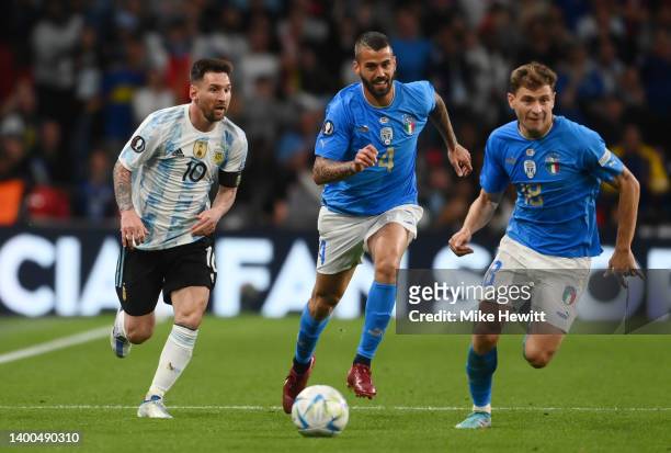Lionel Messi of Argentina is challenged by Leonardo Spinazzola and Nicolo Barella of Italy during the 2022 Finalissima match between Italy and...