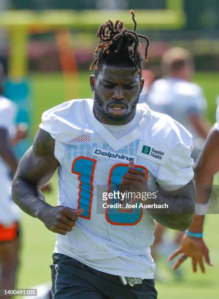 Tyreek Hill of the Miami Dolphins warms up during the Miami Dolphins OTAs at the Baptist Health Training Complex on June 1, 2022 in Miami Gardens,...