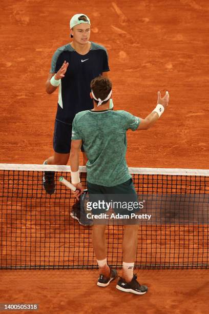 Casper Ruud of Norway and Holger Rune of Denmark shake hands following the Men's Singles Quarter Final match on Day 11 at Roland Garros on June 01,...