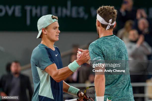 Casper Ruud of Norway shakes hands with Holger Rune of Denmark after winning match point during the Men's Singles Quarter Final match on Day 11 at...