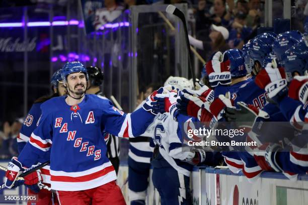 Chris Kreider of the New York Rangers celebrates with his teammates after scoring a goal on Andrei Vasilevskiy of the Tampa Bay Lightning during the...