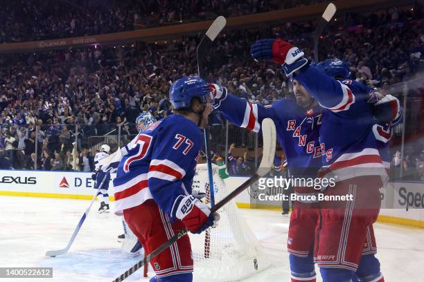Chris Kreider of the New York Rangers celebrates with his teammates Mika Zibanejad and Frank Vatrano after scoring a goal on Andrei Vasilevskiy of...