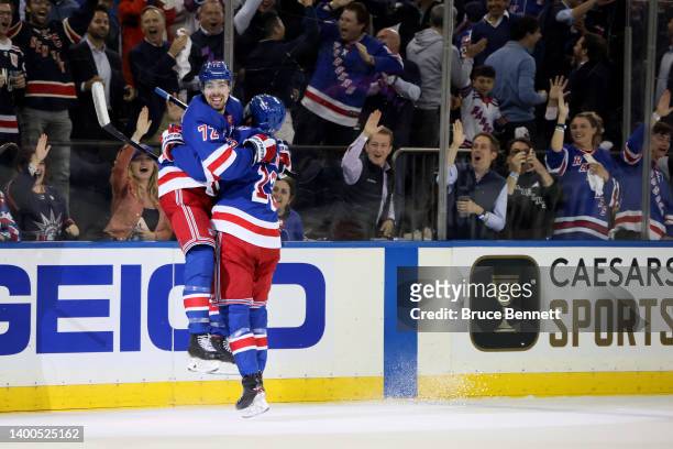 Filip Chytil of the New York Rangers celebrates with his teammate Alexis Lafreniere after scoring his second goal on Andrei Vasilevskiy of the Tampa...