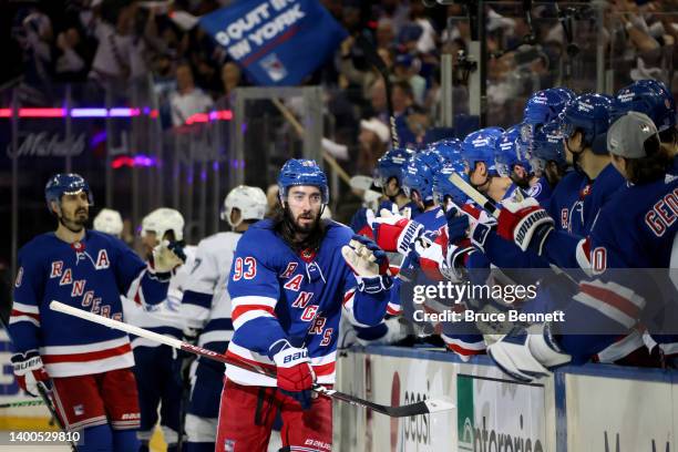 Mika Zibanejad of the New York Rangers celebrates with his teammates after scoring a goal on Andrei Vasilevskiy of the Tampa Bay Lightning during the...