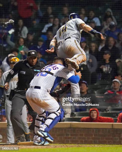 Jace Peterson of the Milwaukee Brewers is out at home on a fielder's choice on the tag by Willson Contreras of the Chicago Cubs in the 10th inning at...