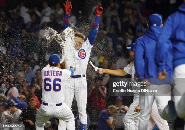 Christopher Morel of the Chicago Cubs is doused by teammates following a walk-off single in the 10th inning against the Milwaukee Brewers at Wrigley...