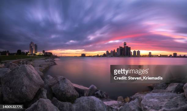 the detroit and windsor skyline at dusk - michigan stock pictures, royalty-free photos & images