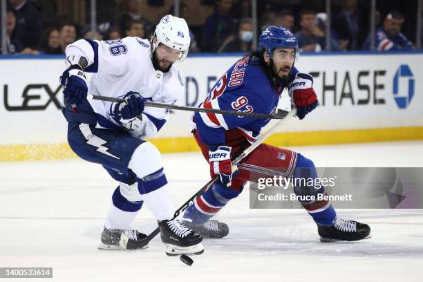 Mika Zibanejad of the New York Rangers skates against Nikita Kucherov of the Tampa Bay Lightning during the third period in Game One of the Eastern...