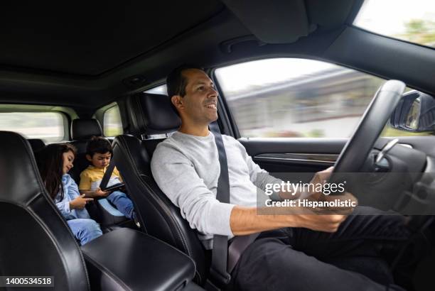 happy father driving his kids to school - child car tablet stock pictures, royalty-free photos & images