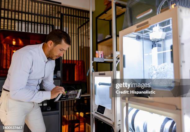 man working at a creative office and printing a 3d object - new business model stock pictures, royalty-free photos & images