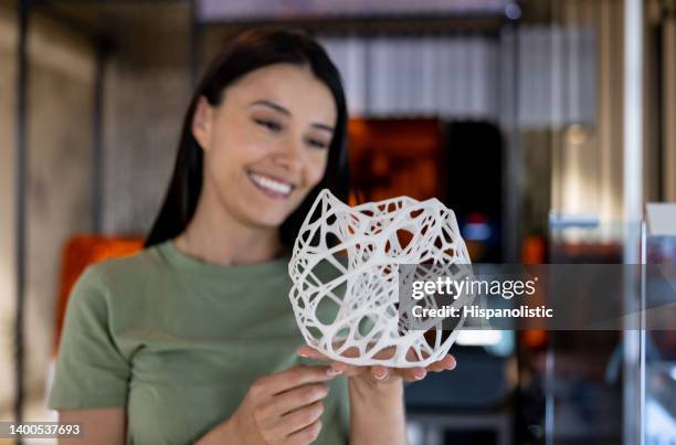 designer working at a creative office and holding a 3d printed model - prototype stock pictures, royalty-free photos & images