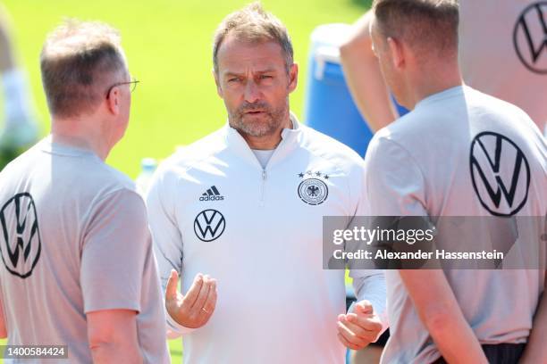 Head coach Hans-Dieter Flick talks to his team doctors Prof. Dr. Tim Meyer and Dr. Jochen Hahne during a training session of the German national...